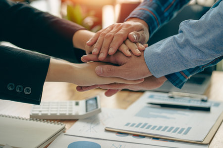 Successful negotiation and handshake concept Two businessmen shake hands with partners to celebrate...