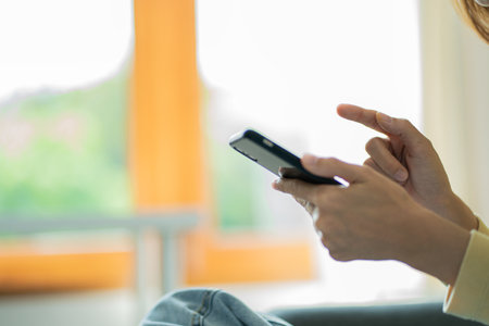woman pointing at smartphone screen Chat on social networks, search for information on the Internet,...