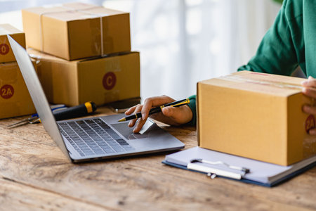 <p>Startup or Small Business Entrepreneur prepare to deliver with parcel box note delivery address...