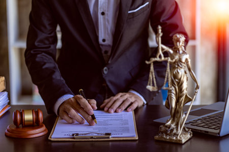 Male lawyer in suit or judge working on documents legal and justice advice Businessman working at...
