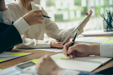 Business team analyzing data using computer while spending time in office Financial planning, strategy and brainstorming with Financial Accounting Concept Colleaguesの写真素材