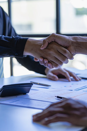 Two confident businessmen shaking hands during meeting in office Successful collaboration and contact, greeting and partnership in business. Portrait image.の写真素材