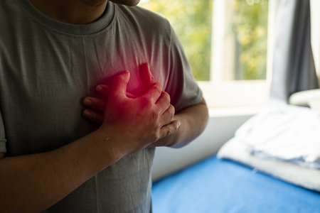 Chest pain, young asian man having a heart attack, man suffering from sadness health concept heart...