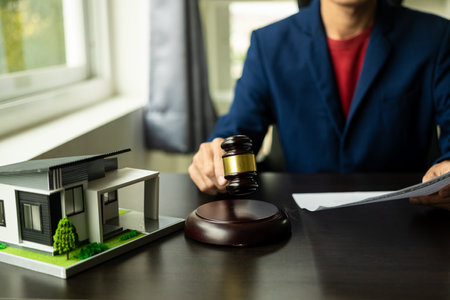 Judge and lawyer at auction with auction house model, house concept, real estate auction conceptの写真素材