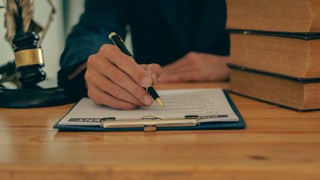 Lawyer working in the office law and justice concept male judge Businessman's consultant legal service Advising on various contracts to plan a case in court.の写真素材