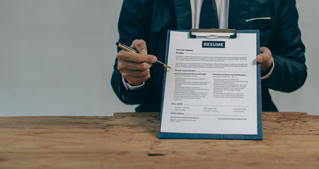 Send resumes to employers to review job applications. The concept presents the company's ability to agree on job positions. Executive reading resume during job interview and busineの写真素材
