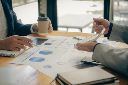 Company financial growth and strategy meeting at office Excited colleagues working on laptop celebrating financial department success, collaboration conceptの写真素材