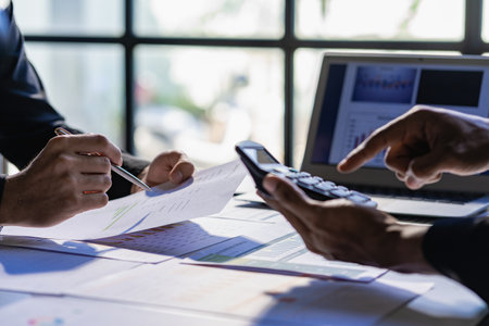 Asian business people meeting, planning and discussing chart data analysis. financial calculations and business efficiency Accounting concept. Marketing. Teamwork with analytical pの写真素材