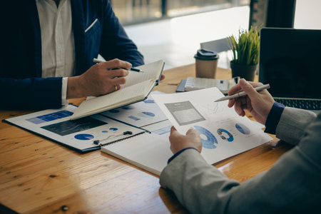 Asian business people meeting, planning and discussing chart data analysis. financial calculations and business efficiency Accounting concept. Marketing. Teamwork with analytical pの写真素材