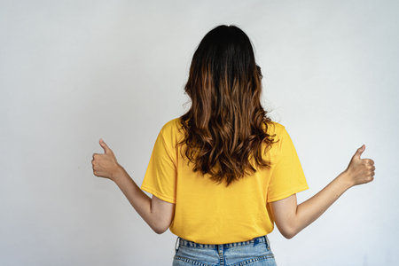 Attractive Asian beautiful woman standing on white background and doing hand gestures.の写真素材