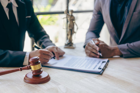 Businessmen and lawyers meeting to discuss contract documents sitting at table Legal concept. Advice. Injustice legal service in a lawyer office.の写真素材