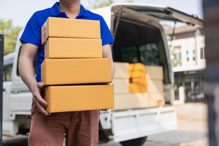 Delivery concept. Asian man. Hand receiving delivery box from professional courier at home. Man in...