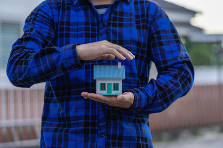 insurance concept Protect the house to take care of the people in the house. real estate project The concept of life and property insurance.の写真素材