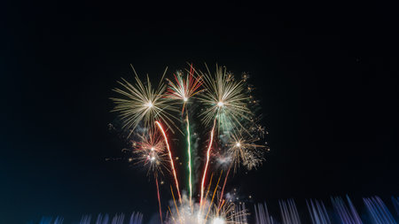 fireworks on a black background Frame or border from golden sparks and firecrackers isolated on new year night fireworks and bokeh lights on dark blue night sky background.の写真素材