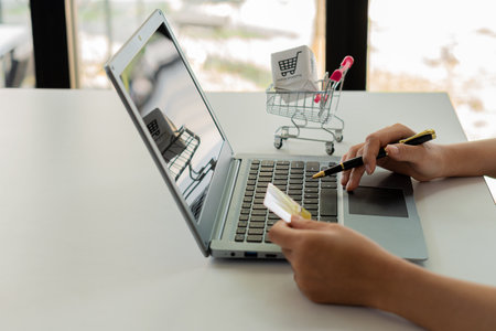 Asian woman paying online using laptop for home shopping and woman shopping online with credit card. pay online Shop online. Pay by internet bankingの写真素材