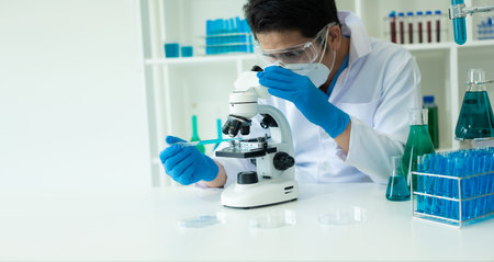 Researcher with chemical test tubes in a glass laboratory with liquid for analytical, medical,...