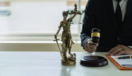 Advice and concept of justice Justice scales and judge hammer, lawyer using pen doing legal work at...