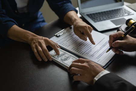 The concept of bribery and corruption, bribery in the form of dollars. Businessman giving money to...