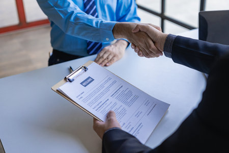 handshake during job interview Male candidate shaking hands with interviewer or employer after job interview Hiring and recruiting in the officeの写真素材