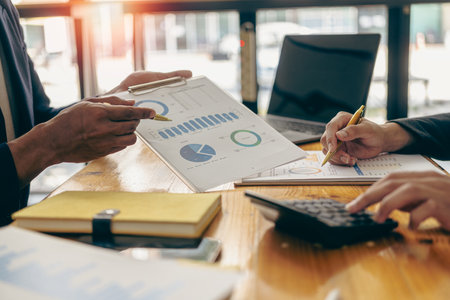 Businessman and Certified Public Accountant Accounting services and auditing on company charts and stock market data at teamwork concept meetings.の写真素材