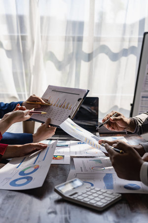 Business team meeting using calculator Work with charts and analyze business strategies. financial...