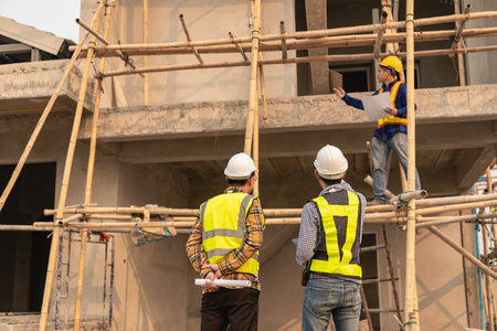 Civil engineers inspect work with walkie-talkies for communicating with the management team....