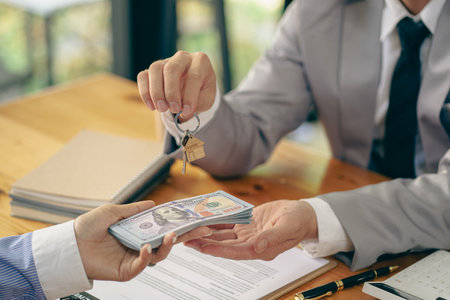 Sales representative handing over the keys to the customer New home buyers will be approved for home...