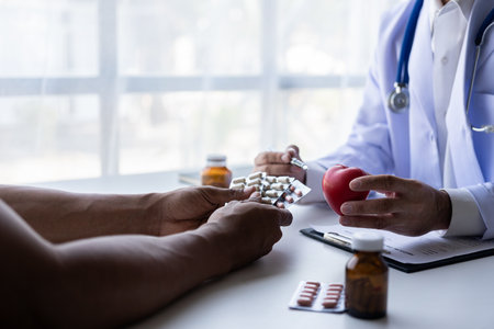 Doctor talking to patient and filling patient history. Examination, treatment. Medical and health concept. Men's disease prevention, health, medical services, consultation,の写真素材