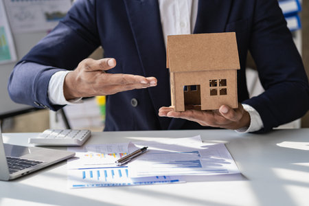 The concept of buying and selling real estate housing estates. The salesperson calculates the price and explains the details of the transaction to the customer and gives advice onの写真素材