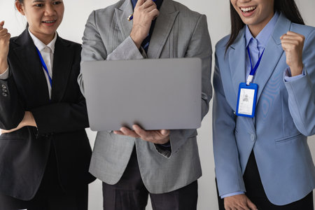 Young asian business people financial analysis meeting brainstorming on new business together with laptop and financial accounting graph papers in officeの写真素材