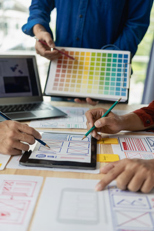 The web ux ui design team is writing code and layers to customize the smartphone front ux ui display. To develop mobile responsive websites with previews. vertical imageの写真素材