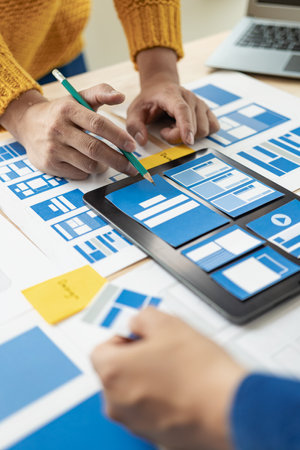 The web ux ui design team is writing code and layers to customize the smartphone front ux ui display. To develop mobile responsive websites with previews. vertical imageの写真素材