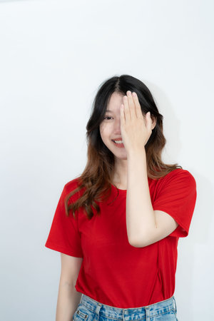 Positive Asian woman thinking creative choice on white background Smiling girl thinking about questions some brooding expressionsの写真素材