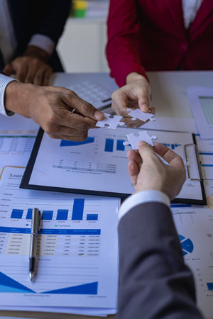 Business team meeting using calculator Working with laptop and charts and analyzing business...
