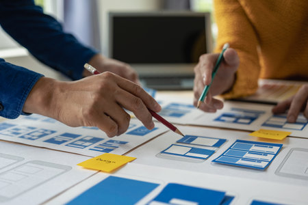 A team of UI UX web designers is working together to develop a mobile responsive website by...