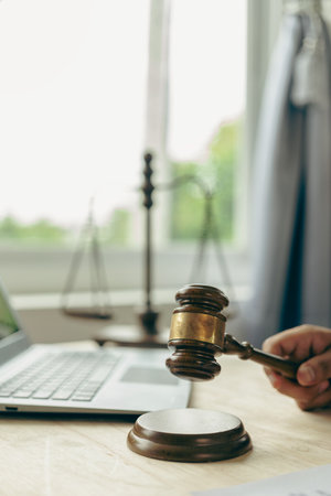 Judge hammer with judge, lawyer, businessman in suit working on legal documents in courtroom,...