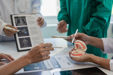 Medical teams sit in meetings with laptops around tables. Doctors and staff discuss documents and test results. Healthcare professionals in hospitals Close-up pictureの写真素材