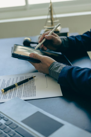 Male lawyer working with contract documents and wooden hammer on table in courtroom, justice and law, court judge, justice lawyer concept, legal advice and service vertical pictureの写真素材