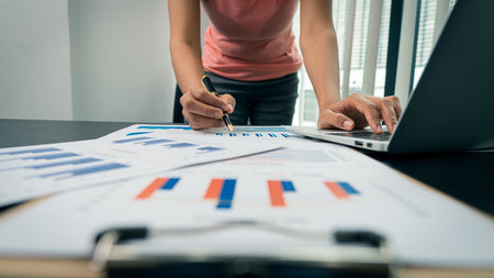 Businessman pointing at business document for chart and graph data analysis and accounting business...