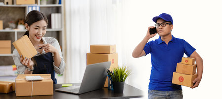 Starting a small business, SME owners, Asian men and women Operator working with parcel boxes and checking online orders to prepare to pack boxes Sell ââto customersの写真素材