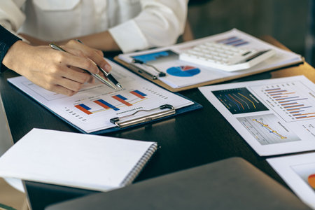 Accountant holding documents preparing performance analysis report Executives create documents at...