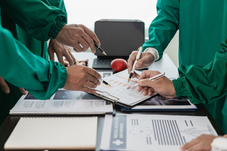 Meetings and laptops for office teams to discuss brainstorming and planning. Doctors, nurses, and computers on desks demonstrate the diversity of collaboration. Close-up picturesの写真素材