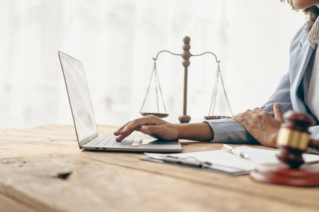 Female lawyer working in office or court with hammer and scale, justice on table, online legal advice, lawyer, consultant, justice and law, lawyer concept, close-up imageの写真素材