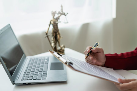 Asian female lawyer working in office or court with hammer and justice pad on table, online legal advice with new laws of real estate business. Law, legal service, advice, justice.の写真素材