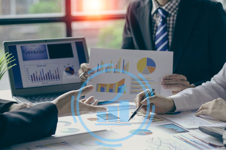 A team of analysts works on a financial data analysis dashboard on paper to use as market indicators...