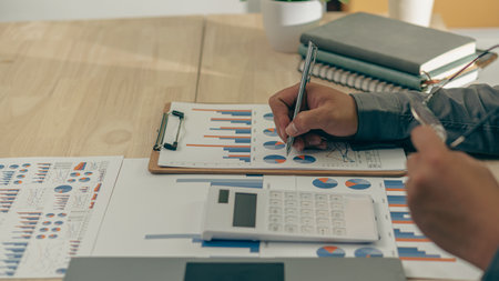 Business accounting concept Businessman uses calculator with laptop computer Budget and borrowed...