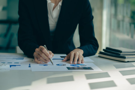 Business accounting concept Businessman uses calculator with laptop computer Budget and borrowed paper Calculate expenses, expenses, taxes online, manage company budgets, close-upの写真素材