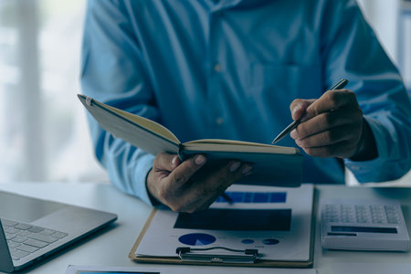 Businessman analyzing company financial report, balance sheet, working with document graphs Save photos for the stock market, office, taxes, close-up photos.の写真素材