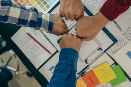 Young business people shaking hands and meeting with documents above to hire a partner or work...