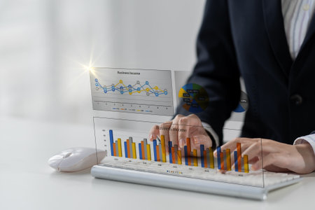 Confident businesswoman working on laptop in her office, female accountant or banker doing...